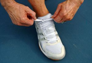 Woman lacing up sneakers