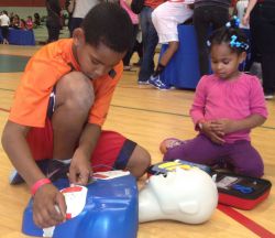 Youth learning how to use AED