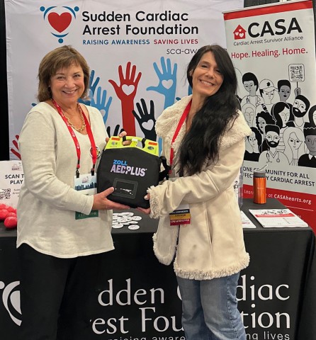 Mary Newman presents ZOLL AED to survivor Amy Sauro
