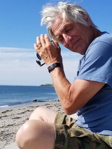 Dad sitting by the beach