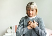 Woman holding chest