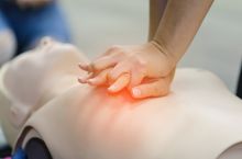 Practicing CPR on manikin