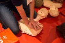 Hands doing CPR on mannequin