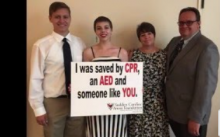 Group of 4 holding "I Survived" sign
